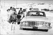Group of Inuit around a taxi [graphic material] n.d.