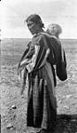 Inuit woman carrying a baby in the hood of her amauti [graphic material] ca. 1926 - 1943.