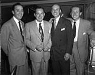 Musicians, including Jimmy Dorsey (second from left), taking a break from playing at the Standish Hotel and posing for photograph. Jimmy Dorsey was the older brother of Tommy Dorsey ca 1950.