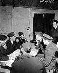 Debriefing of aircrew of No. 433 (Porcupine) Squadron, RCAF, after a raid on German flying-bomb sites in France [graphic material] 1944