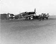 Pilots at readiness with a Hawker Hurricane I aircraft of No. 1 (F) Squadron, R.C.A.F. [graphic material] : Digby, England, 22 January 1941 January 22, 1941