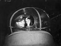P/O Murray Stewart in the mid-upper turret of an Avro Lancaster B.II aircraft of No. 432 (Leaside) Squadron, R.C.A.F. [graphic material] : East Moor, England. The turret's perspex was shattered by a shell from a German night-fighter during a raid on Brunswick, Germany, on 14/15 January 1944 January 15, 1944.
