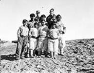 Group of Inuit boys at Thule. Captain H.H. Keivan USN in back row 1949