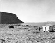 Construction of Inuit houses by the shore, Mount Thule, Northwest Territories [Nunavut] 1949