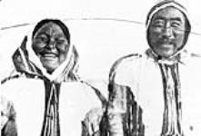 Inuit couple wearing traditional caribou parkas May, 1916