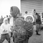 Inuk seamstress "Ookshout" (Mary) carrying her son "Kukshow" Summer 1963
