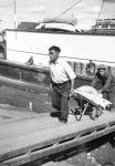 Two Inuit men unloading barge 1944