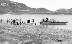 Group of Inuit unloading barges 1944