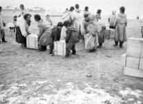 Inuit families helping to unload supplies at Clyde River (Kangiqtugaapik) 1944