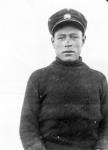 Inuk man wearing a uniform cap and turtleneck sweater July, 1926