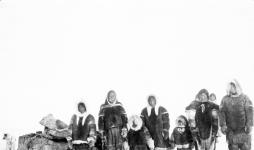 Inuit group dressed in caribou parkas. Part of L.T. Burwash's party crossing Boothia Peninsula April, 1926