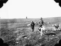 Inuk man and boy with pack dogs on hunting trip September, 1930