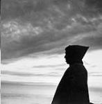 Inuk man in silhouette against the sky 1948