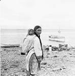 Inuk girl carrying her baby sister in her amauti (parka) at Repulse Bay (Naujaat/Aivilik) 1948