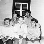 Alan Scott with Inuit men (L. to R.) John Ell, Kooshevak, Narlaktuk, Poomeeoolik [Left to right: Aulannaq, John Ell, Qusagat, Naalaktuq, Laurent Pameolik, Atausiq] 1948.
