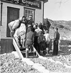 Jim [James] Houston showing a drawing to the local Inuit 1949