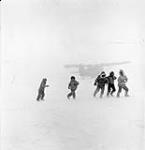 Five Inuit boys at Bathurst Inlet (Qingauq) playing near the seaplane "Norseman" 1950