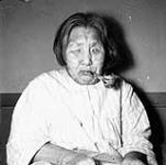 Elderly Inuk woman with face tattoos in the Industrial Home at Chesterfield Inlet (Igluligaarjuk) 1950
