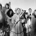 Inuk woman "Sic Sic" performs with child's drum 1950