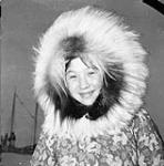 Inuk girl in a floral parka with fur trim at Rymer Point 1950