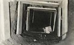 [Red Rock Internment Camp, Ontario (Camp R) - Picture of tunnel dug by prisoners under their huts - The tunnel was discovered before the prisoners could make their escape] [ca. 1940-1941].