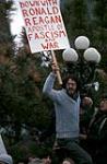 [Protester carrying sign reading "Down with Ronald Reagan Apostle of Fascism and War"] March 1981.