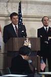 [Pierre Trudeau looks on as Ronald Reagan speaks at podium] March 1981.