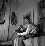 [Louis Muhlstock seated and holding a book] 1941 ?.