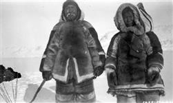 [Inuk man and his wife out sealing on ice] Original title: Native hunter and wife out sealing on ice March 1929.