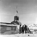[J.C. Jackson and Inuuk men at Roman Catholic Mission] Original title: J.C.Jackson and Eskimos at R.C.Mission 1953