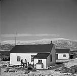 Dr. James C. Osborne with his wife, Wanda, on the porch of the medical officer's residence in Pangnirtung August, 1946.