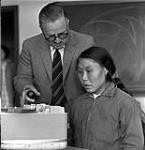 Mr. D.M. Davies and an Inuit student, Elisapi Napaartu, at the Eskimo Language School, Fort Churchill, Manitoba 1961.