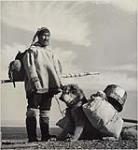 Illustration 27 - Spring break-up at Boothia, man [Sakiasi Anaija] and dog carrying camping gear April 1953.