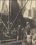 [Fisherman on dock with boats, New York] [19-?].