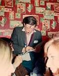 Milton Acorn autographing book, after receiving medal from friends when he failed to receive the Governor-General's Award for poetry. Grossman's Tavern 16 May 1970