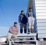 Three printmakers outside the Cape Dorset Craft Centre, Cape Dorset, N.W.T. [Cape Dorset (Kingnait), Nunavut] [between June-September, 1960].