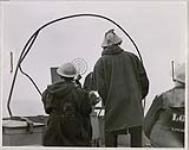 [Two seamen dressed in duffle coats at Oerlikon gun] [ca. 1945].