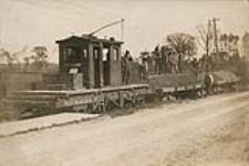 [Woodstock Thames Valley and Ingersoll Electric Railway - Flat car locomotive with ballast cars and workers - Woodstock Ingersoll Highway] [ca. 1901].