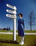 Women's Royal Canadian Naval Service "Wren" summer uniform [Wren standing near signpost indicating HMC shore establishments] 1943