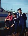 RCN Motor Torpedo Boat sailors Lucien Boucher and Frances Lariviere talking to a Belgian fisherman, Ostend, Belgium [ca. 1942-1945]