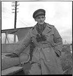 Near Grave - Warco Douglas Amaron beside his jeep February 11, 1945.