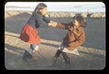 Girls playing outside in Iqaluit, Nunavut [between June 17-August 24, 1960]