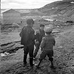 [Three boys playing outside] [between 1956-1960]