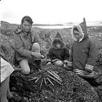 [Enosil, Jo and a girl preparing a campfire, Iqaluit, Nunavut] [between 1956-1960]