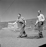 [Bob Green (right) playing horseshoes with another man, Niaqunngut, Iqaluit, Nunavut] [between 1956-1960]