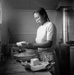 [Woman cooking in a kitchen] [between 1956-1960]