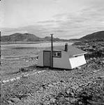 [Rigid digit house near the shoreline] [between 1956-1960]