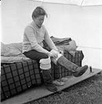 [Barbara Hinds putting on boots] [between 1956-1960]