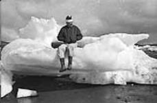 [Mackenzie Porter sitting on a block of ice] [between 1956-1960]