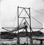 [Man standing on a bridge] [between 1956-1960]